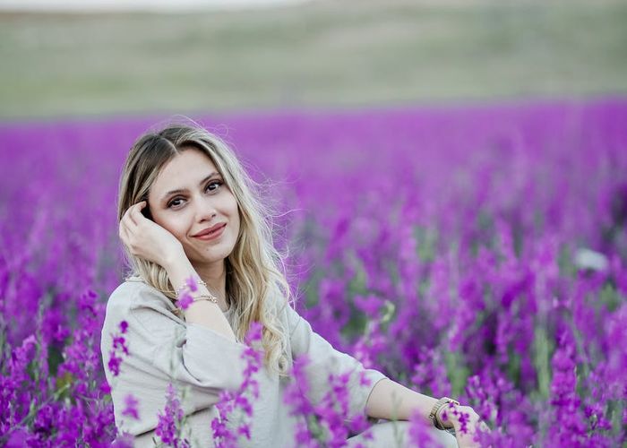 Person smiling and looking relaxed after a gentle workout, sitting on a mat.